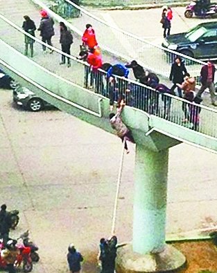 女子翻天橋護(hù)欄欲輕生 掉下瞬間被路人拉住(圖)