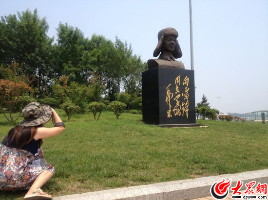“聚焦美麗山東——第九屆中國(guó)網(wǎng)絡(luò)媒體山東行”南線采訪團(tuán)來到日照好人廣場(chǎng)，圖為記者在用攝像頭記錄好人廣場(chǎng)上的雷鋒雕像。
